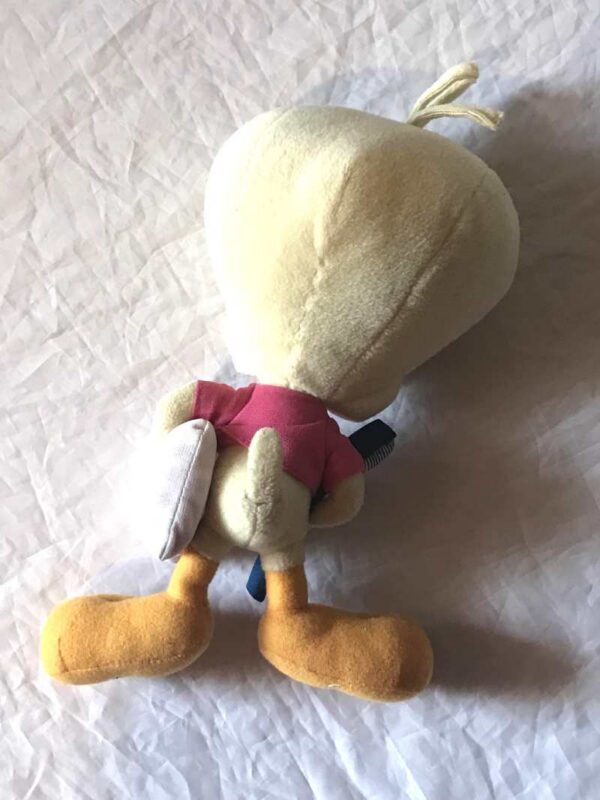 Arrière peluche normale petit titi jaune oreiller blanc brosse à dents bleue