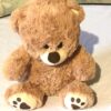 Peluche normale petit ourson brun traces pattes marrons sous pieds